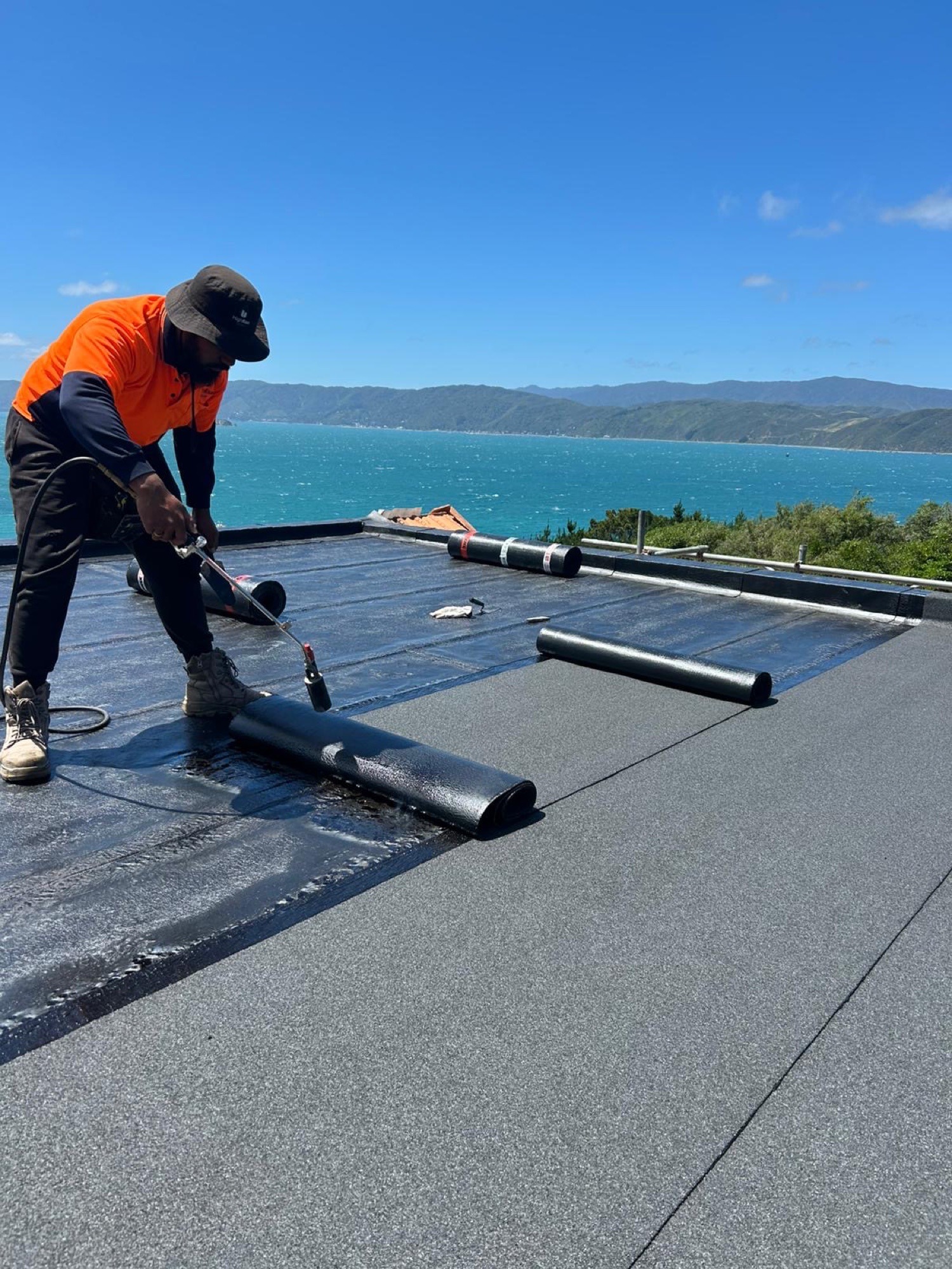 Torch-on membrane being applied by a Highrise technician